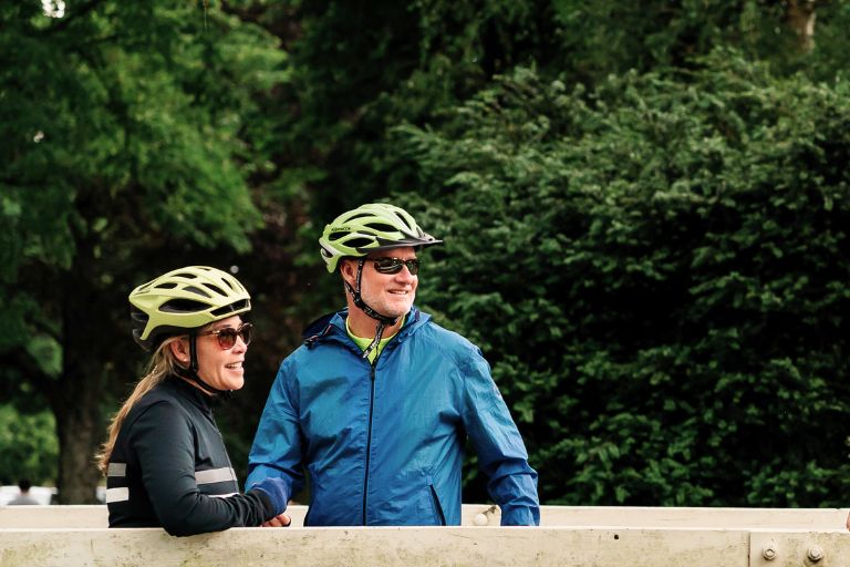 Two cyclists with helmets on