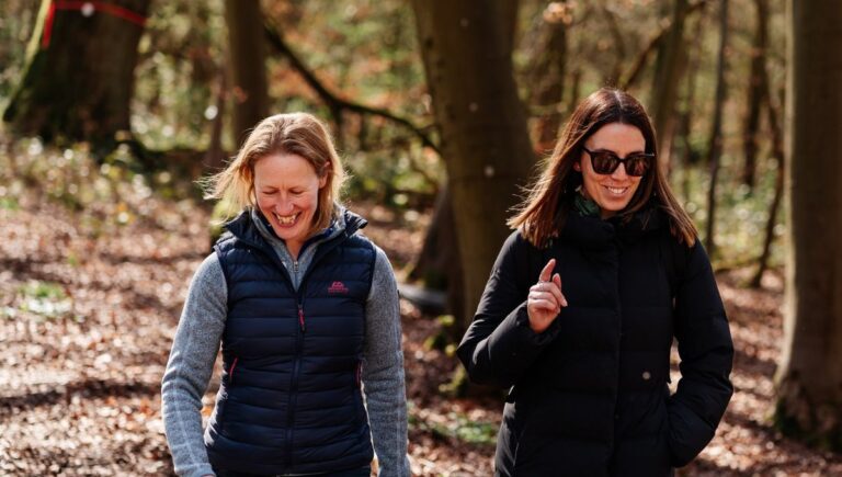 Two women walking in woods