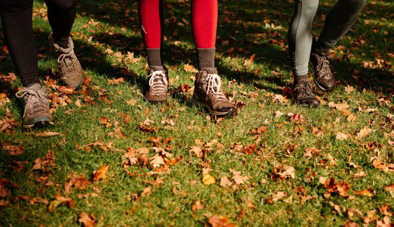 Three people with walking boots in Autumn