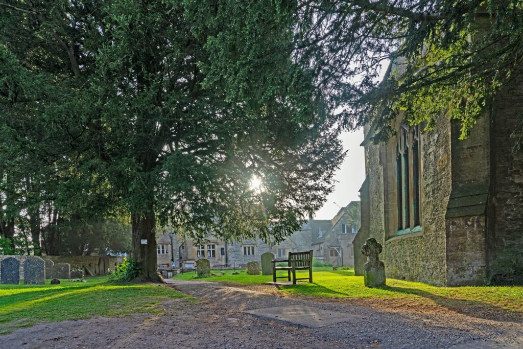 Sunshine through the trees at St Edwards church Stow on the Wold