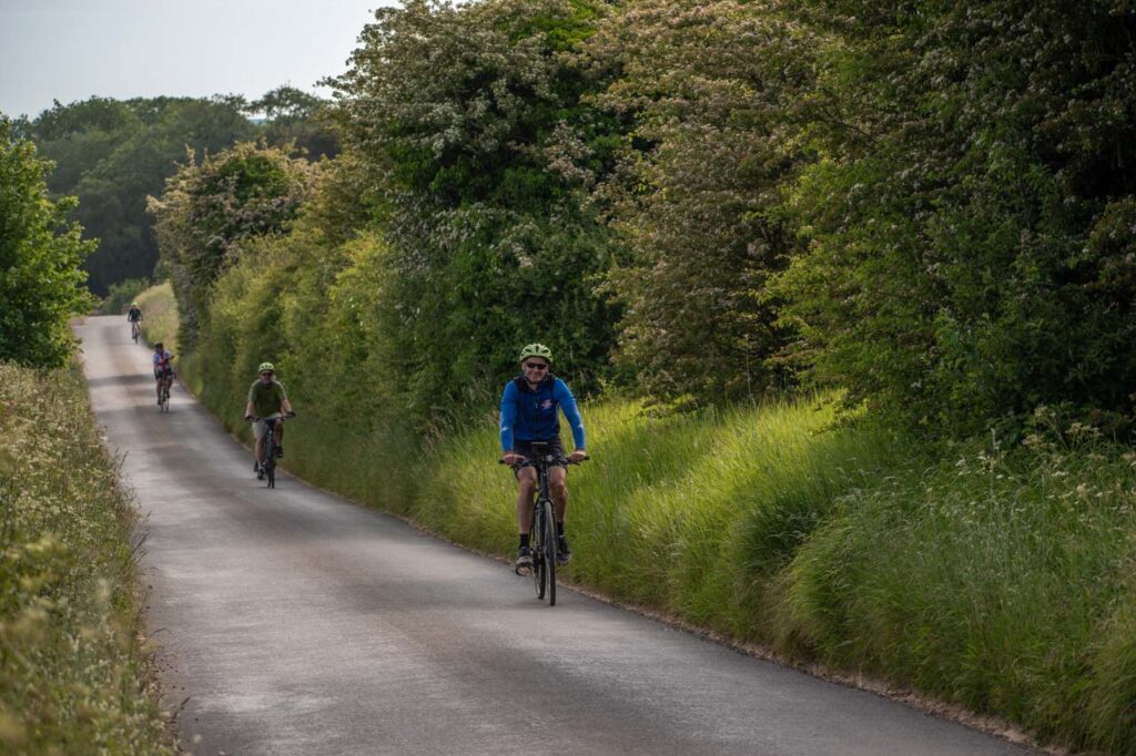 Four cyclists on a country road in England