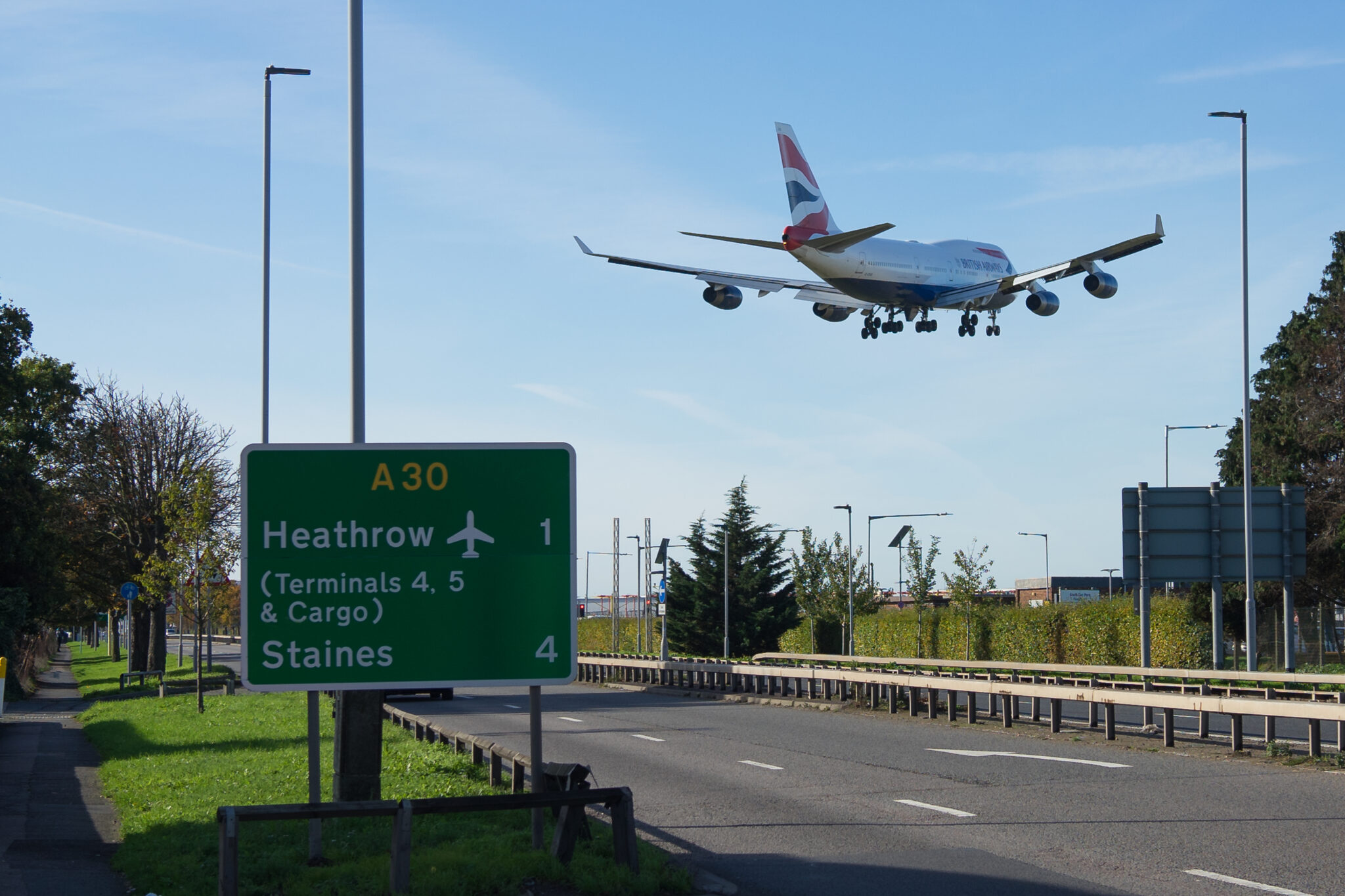 London Heathrow road with British Airways 747 flying overhead