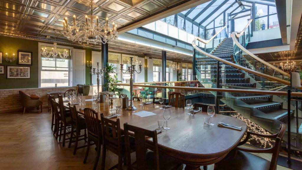 Dining table with sweeping staircase in Hall & Woodhouse